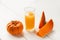 Fall drink concept. Fresh pumpkin juice in a glass Cup with seeds and orange pumpkins. Healthy and tasty food concept. Copy space