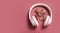 Fall flat lay composition with realistic leaves and white headphones on pink background. Autumn podcast background