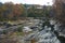 Fall foliage hugs the Ottauquechee River.