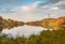 Fall foliage surrounds Lake Marcia as High Point Veteran`s Monument stands atop the mountain at sunset