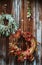 Fall front porch. autumn wreath and pumpkins on old wooden rustic background at doors.