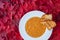 Fall harvest bisque soup of pureed squash and other fall vegetables, in a white bowl with toasted bread, on a background of red ma