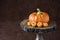 Fall harvest, orange ceramic pumpkin surrounded by chocolate shaped as pumpkins