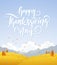 Fall hillside landscape with handwritten lettering of Happy Thanksgiving Day