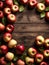 A fall inspired wooden effect background with copy space with red apples