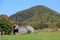 Fall landscape of mountains and farmhouse