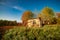 Fall landscape with old damaged wooden house