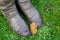 Fall leaf rests on a woman\'s winter boots