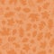 Fall leaves seamless vector background. Orange leaf silhouettes on light orange. Acorns, oak tree, maple tree pattern. Subtle