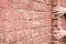 Fall. Man holds onto a ledge on a brick wall.