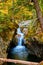 Fall narrow gorge in Vermont with stunning waterfall raging through