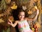 Fall nature gifts. Autumn coziness is just around. Tips for turning fall into best season. Kid girl smiling face lay