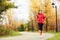 Fall running - woman jogging in autumn