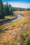 Fall scenery of a river winding through meadows and forests behind a fence - in the Modrava valley, Sumava, Czechia