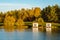 Fall season landscape with floating grey cabins on the lake