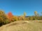 Fall season at the mountain with colorfully trees, meadows and hills