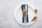 Fall season table setting with white plate and decorated cutlery