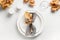 Fall table setting with autumn leaves and white plate on white table. View from above