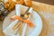 Fall Thanksgiving or Halloween Table Place Setting and pumpkins in Gold tones. Horizontal with natural lighting from above, lookin