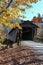Fall view of covered bridges over a river.