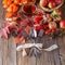 Fall wealth on rustic wooden background with fork and spoon