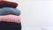 Fall winter fashion trends. Stack of cozy knitted sweaters in retail shop, store. Fashion shopping sale background with copy space