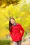 Fall woman walking amongst autumn trees