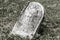 Fallen creepy headstone in a cemetery IV
