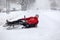 Fallen down Caucasian cyclist lying on slippery snowy pathway, riding bicycle in city at winter season