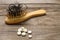 Fallen hair on comb and medicine on table.