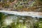 Fallen leaves in water and foam on stream