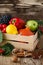 Fallen leaves, winter squash and vegetables in a wooden box. Fall harvest decorating