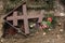 Fallen orthodox cross on an unmarked grave.