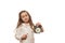 Falling asleep sleepy little child girl in white pajamas posing with closed eyes pointing at alarm clock showing bedtime