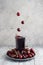 Falling cherry in a glass of juice. Composition in motion, levitation