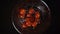 Falling cherry tomatoes in glass bowl, slow motion