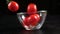 Falling cherry tomatoes in glass bowl, slow motion 250 fps