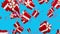 Falling dawn candy cane and presents isolated on blue background 3d render. White and red gifts and candy cane drops