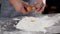 Falling egg into flour. Close up view of man hands breaking cracking raw egg over flour, baking concept. Baker kneads