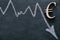 Falling euro currency rate.Euro inflation.Euro sign and a down arrow on a black background. Financial Crisis.European