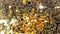 Falling gold glitter foil confetti, super slow motion movement on golden background, holiday and festive fun