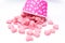 Falling heart candy in Pink polka dot paper cups isolated