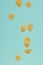 Falling Italian pasta on a light blue background, freezing in motion
