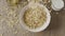 Falling natural oat granola into a ceramic bowl for preparing he