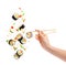 Falling pieces of sushi and sushi roll with wooden chopsticks