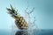 Falling pineapple, water splash on blue background