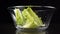 Falling salad leaf in glass bowl, slow motion