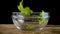 Falling salad leafs to empty glass bowl