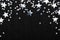 Falling silver stars confetti on black festive background Glowing sparkles frame