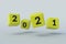 Falling yellow cubes with numbers 2021